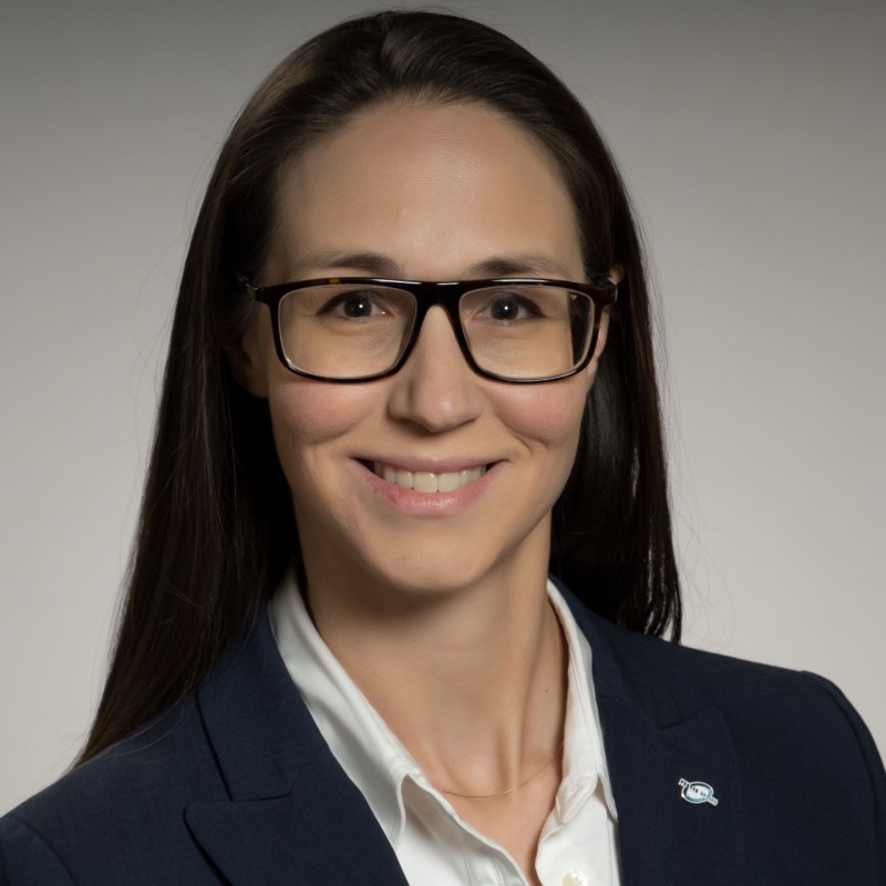 a woman wearing glasses and a suit